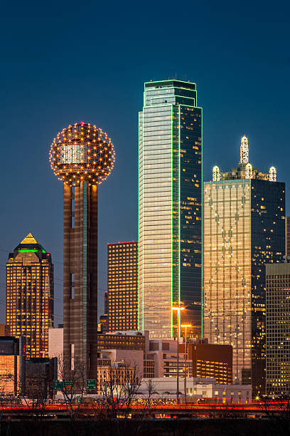 Downtown Dallas TX city scape skyline at dusk with Reunion Tower and the Bank of America building AKA the green skyscraper